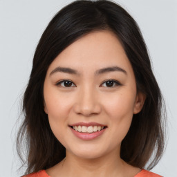 Joyful asian young-adult female with medium  brown hair and brown eyes