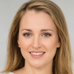 Joyful white young-adult female with long  brown hair and green eyes