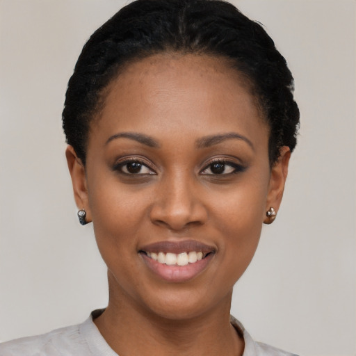Joyful black young-adult female with short  black hair and brown eyes