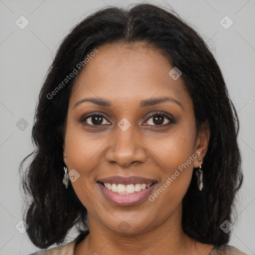 Joyful black young-adult female with long  brown hair and brown eyes