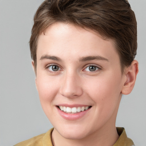 Joyful white young-adult female with short  brown hair and grey eyes