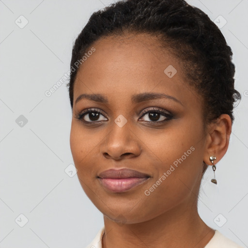 Joyful black young-adult female with short  brown hair and brown eyes