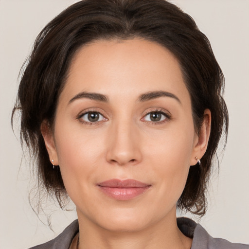 Joyful white young-adult female with medium  brown hair and brown eyes