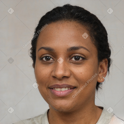 Joyful black young-adult female with short  black hair and brown eyes