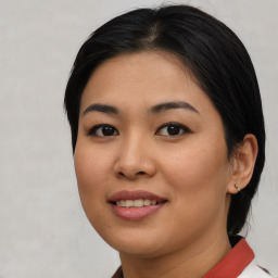 Joyful asian young-adult female with medium  brown hair and brown eyes