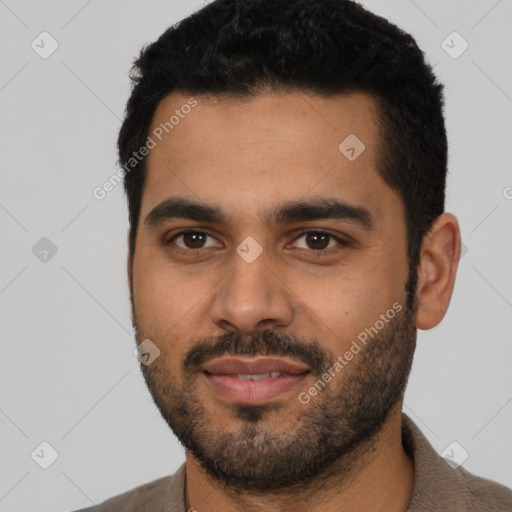 Joyful latino young-adult male with short  black hair and brown eyes