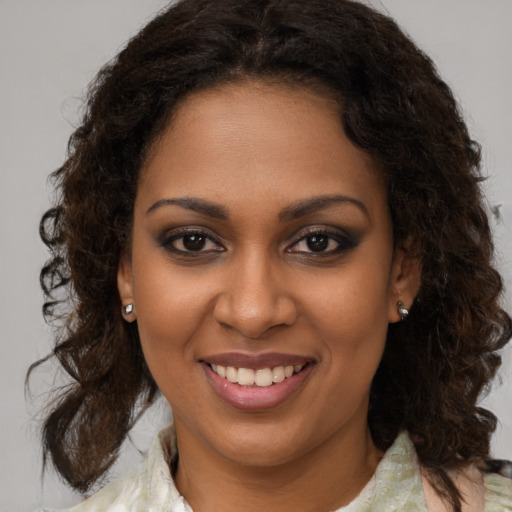 Joyful black young-adult female with medium  brown hair and brown eyes