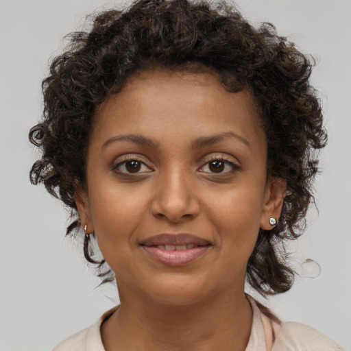 Joyful black young-adult female with medium  brown hair and brown eyes