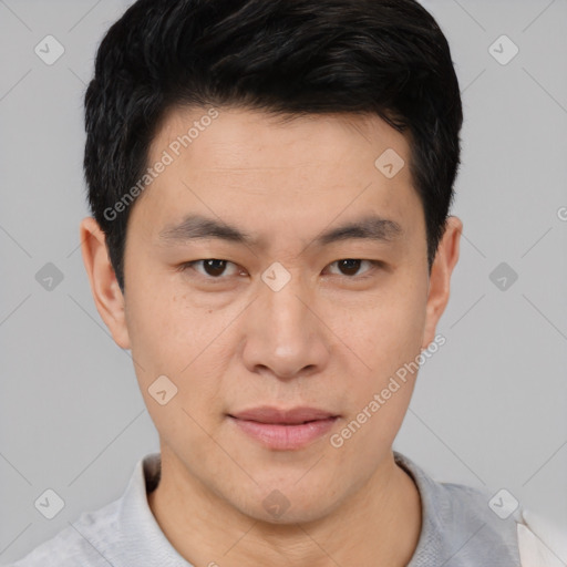 Joyful asian young-adult male with short  black hair and brown eyes