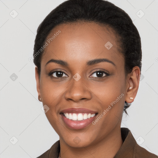 Joyful black young-adult female with short  black hair and brown eyes