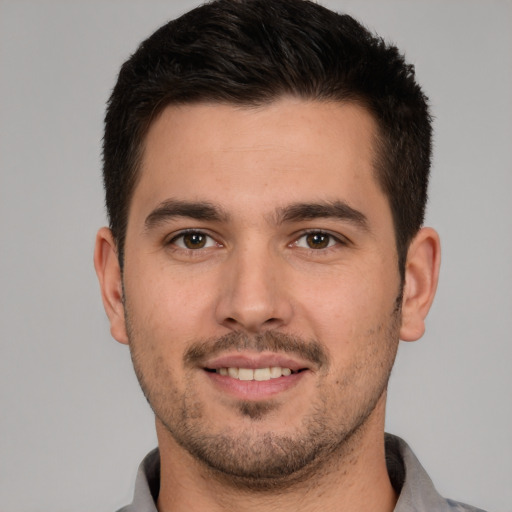 Joyful white young-adult male with short  brown hair and brown eyes