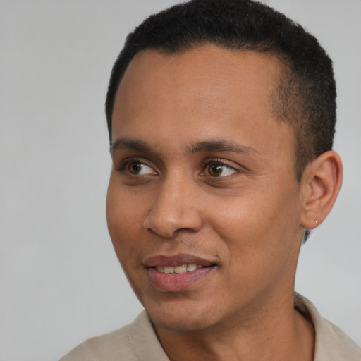 Joyful latino young-adult male with short  brown hair and brown eyes