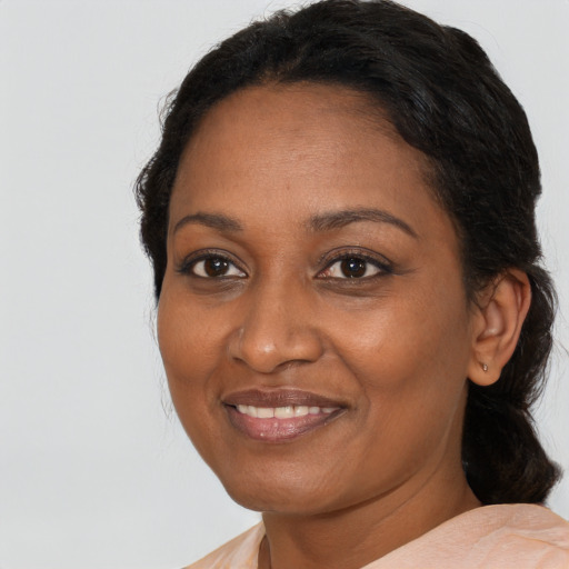 Joyful black adult female with medium  brown hair and brown eyes