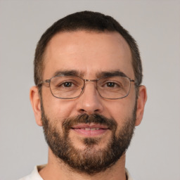 Joyful white adult male with short  brown hair and brown eyes