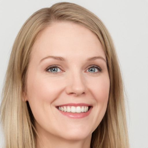 Joyful white young-adult female with long  brown hair and blue eyes