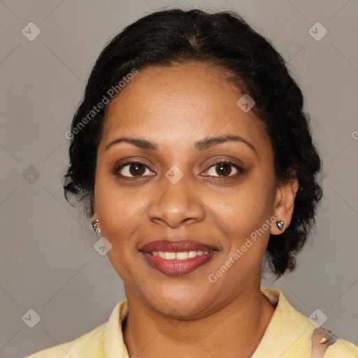 Joyful black adult female with medium  brown hair and brown eyes