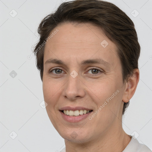 Joyful white adult female with short  brown hair and brown eyes