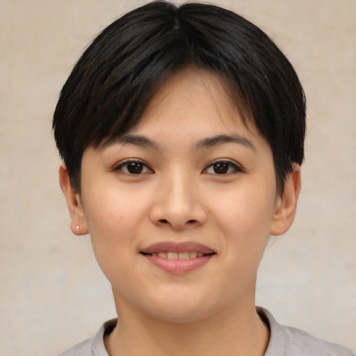 Joyful asian young-adult female with short  brown hair and brown eyes