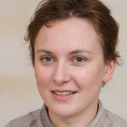 Joyful white young-adult female with medium  brown hair and blue eyes