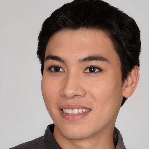 Joyful asian young-adult male with short  black hair and brown eyes