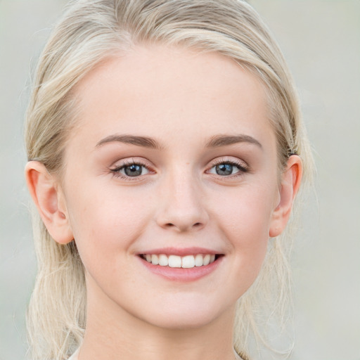 Joyful white young-adult female with medium  brown hair and blue eyes