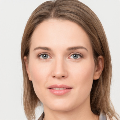 Joyful white young-adult female with medium  brown hair and grey eyes