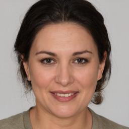 Joyful white adult female with medium  brown hair and brown eyes