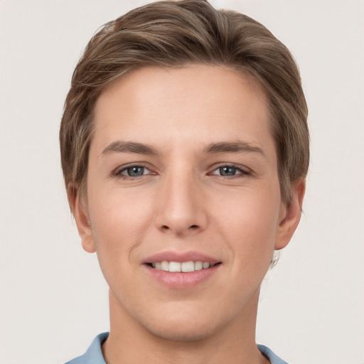 Joyful white young-adult female with short  brown hair and grey eyes