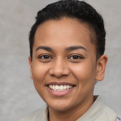 Joyful latino young-adult female with short  brown hair and brown eyes