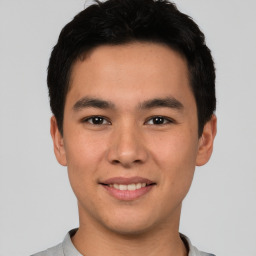 Joyful asian young-adult male with short  black hair and brown eyes