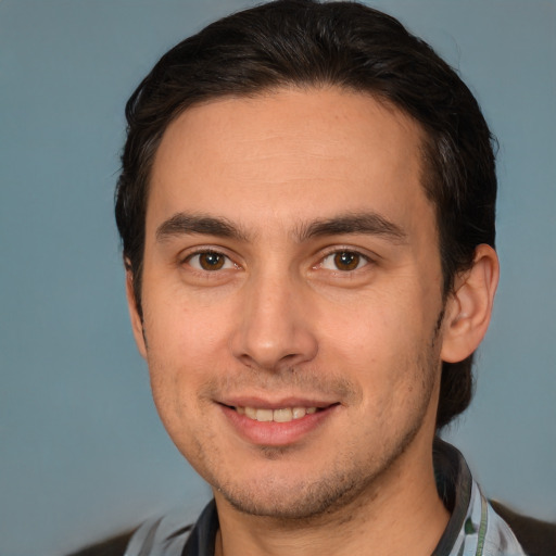 Joyful white young-adult male with short  brown hair and brown eyes