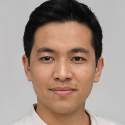 Joyful asian young-adult male with short  black hair and brown eyes