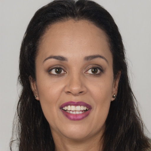 Joyful latino young-adult female with long  brown hair and brown eyes