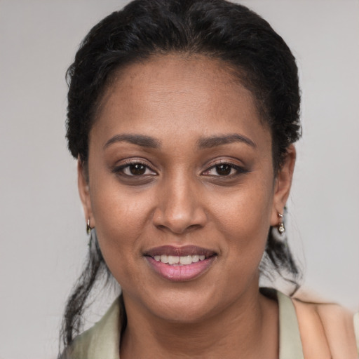 Joyful latino young-adult female with short  black hair and brown eyes