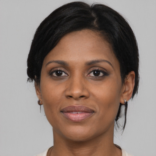 Joyful black young-adult female with medium  black hair and brown eyes
