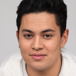 Joyful latino young-adult male with short  brown hair and brown eyes