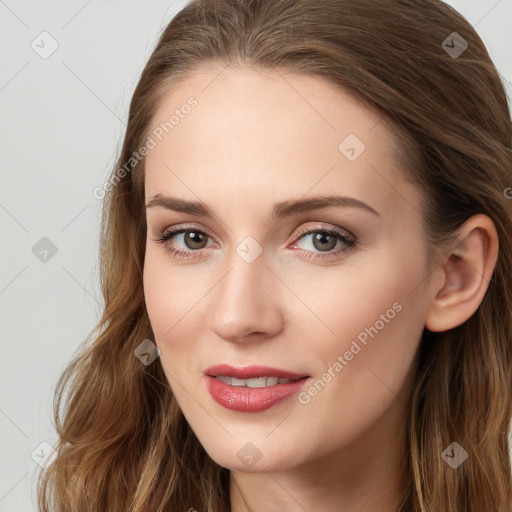 Joyful white young-adult female with long  brown hair and blue eyes