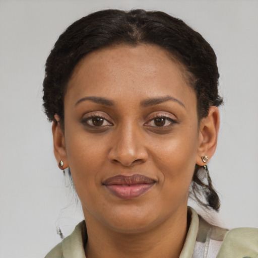 Joyful black young-adult female with short  brown hair and brown eyes