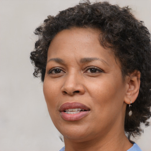 Joyful black adult female with short  brown hair and brown eyes