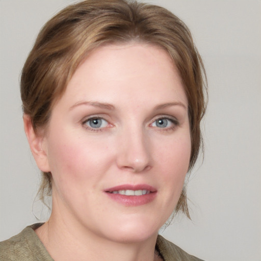 Joyful white young-adult female with medium  brown hair and blue eyes