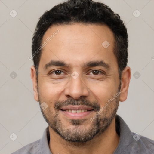 Joyful white adult male with short  black hair and brown eyes