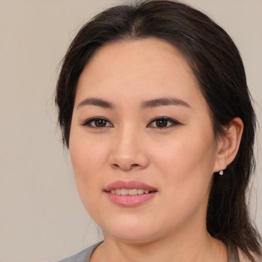 Joyful asian young-adult female with medium  brown hair and brown eyes