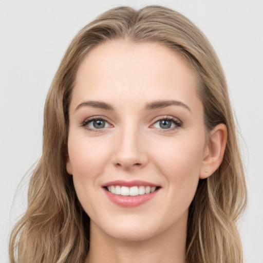 Joyful white young-adult female with long  brown hair and blue eyes