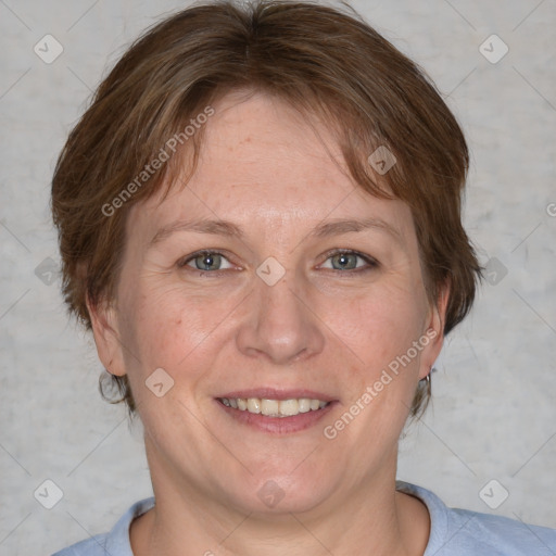 Joyful white adult female with medium  brown hair and blue eyes