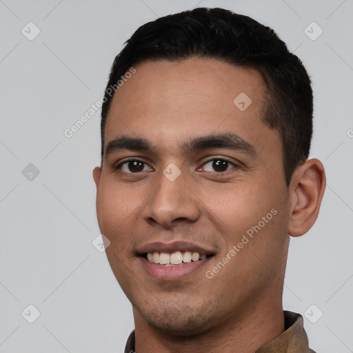 Joyful white young-adult male with short  black hair and brown eyes