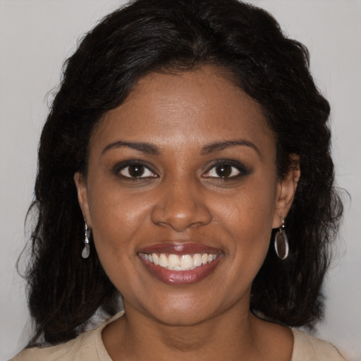 Joyful black young-adult female with medium  brown hair and brown eyes