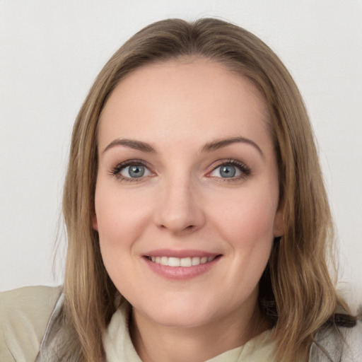 Joyful white young-adult female with long  brown hair and blue eyes