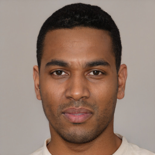 Joyful black young-adult male with short  black hair and brown eyes