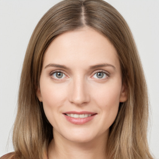 Joyful white young-adult female with long  brown hair and brown eyes