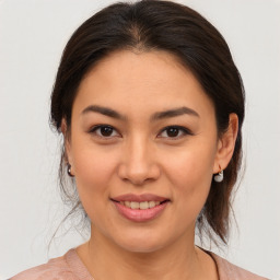 Joyful asian young-adult female with medium  brown hair and brown eyes